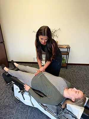 Chiropractor Kenosha WI Gina Caira Adjusting Pregnant A Patient